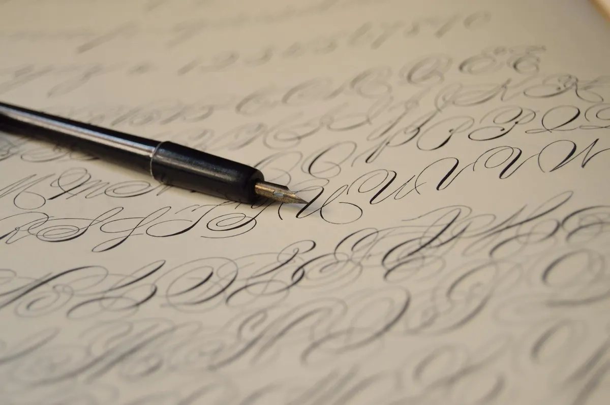 A handwritten wedding invitation in elegant script